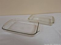 Two rectangular glass baking dishes side by side on table