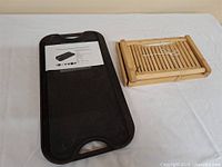 Cast iron griddle and folded bamboo bread slicer side by side on table
