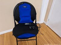 Front view of blue and black Dr. Scholl's heated seat cushion on chair