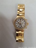 Front view of gold-tone wristwatch showing full bracelet and face