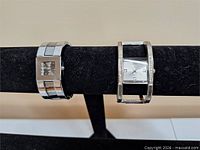 Both watches on display bar showing front faces