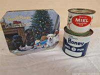 Group shot showing Russell Stover tin and two honey tins