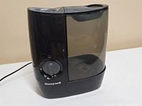 Front view of Honeywell humidifier showing tank and control dial