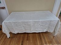 Full view of white linen tablecloth spread on table