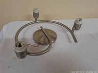 Overall view of brushed nickel ceiling fixture with curved arm and two sockets
