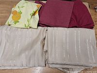 Four folded fabric pieces displayed on table