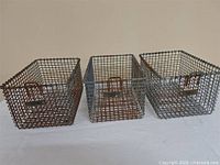 Front view of three wire baskets