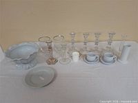 Full lot showing bowl, candlesticks, goblets, cups, saucers, plate, vase and candle