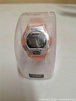 Front view of watch inside clear case showing brand, model and display