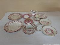 Group view of all eleven pink lustreware pieces on table