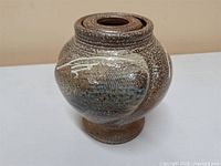 Full view of stoneware vase showing shape and glaze