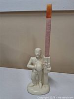 Full view of ceramic candleholder with candle inserted