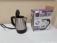 Kettle beside original Salton box showing branding and model