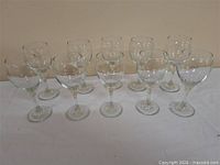 Full set of ten matching clear wine glasses arranged in two rows