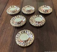Six matching saucers laid out