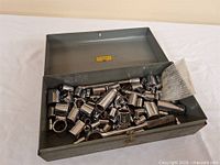 Open metal box with full contents visible