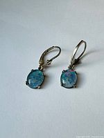 Front view of both earrings showing opal colour and lever-back style