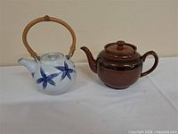 Both teapots side by side on table