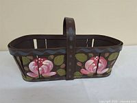Full view of basket showing floral painting and handle