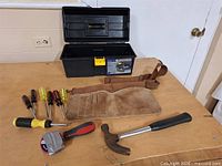 Entire lot laid out: toolbox, belt, screwdrivers, tape measure, hammer