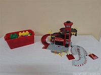 Full view of rescue station assembled beside red bin of blocks