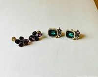 Front view showing both pairs: purple cluster pair and green rectangular pair