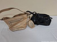 Both purses side by side on table