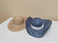 Tan and blue straw hats side by side