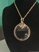 Necklace displayed on black bust showing full pendant detail