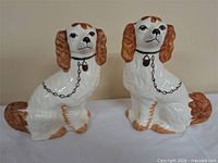 Both porcelain spaniel figurines side by side