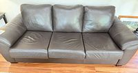 Front view of three-seat leather sofa