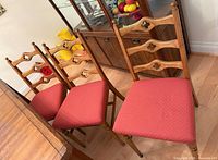 three wooden dining chairs around table
