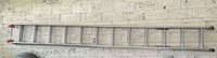 Full view of ladder hung horizontally on wall