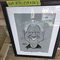 Front view of framed caricature showing artwork, mat, frame and size tape 17 x 14 in.