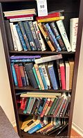 Full view of three-shelf bookcase showing quantity and variety of books
