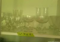 Assorted clear glass stemware on shelf