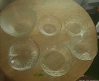 All six assorted clear glass bowls on table