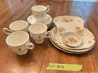 Entire lot showing tea cups, saucers, stacked scalloped trays/plates and small dish