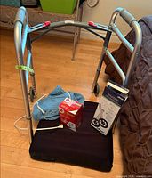 Walker, cushion, BP monitor box, heating pad, wheel kit box