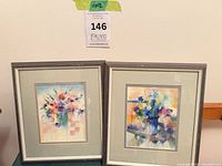 Both framed floral prints side by side to show matching set
