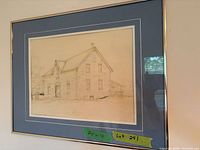 Full view of framed drawing showing house, double mat and frame