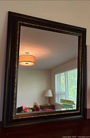 Full view of rectangular framed wall mirror
