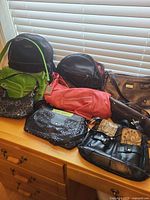 Group shot of all eight bags on dresser