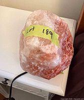 Front view of Himalayan salt lamp showing salt crystal, cord, base