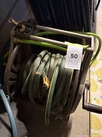 Full view of hose reel with coiled garden hose
