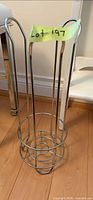 Full view of chrome toilet paper roll holder standing on floor
