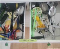 Both drawer sections with assorted utensils visible