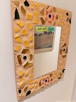 Full view of rectangular mosaic mirror on wall