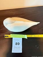 Left-side view showing full length of bird next to measuring tape