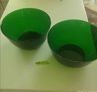 Top view of both green glass bowls side by side